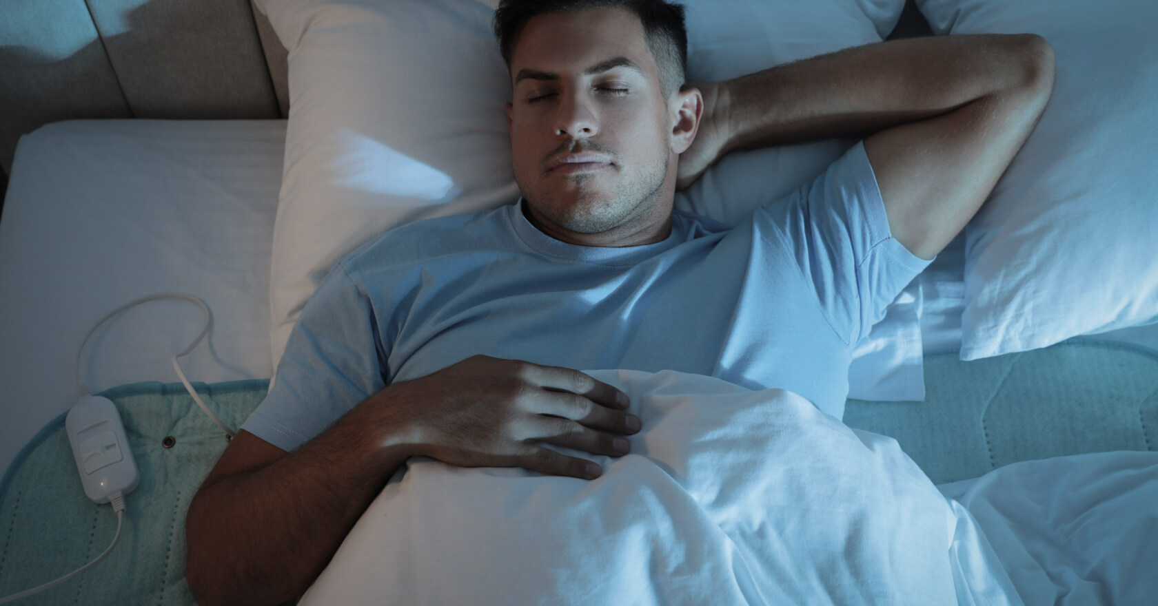 man sleeping soundly with electric blanket