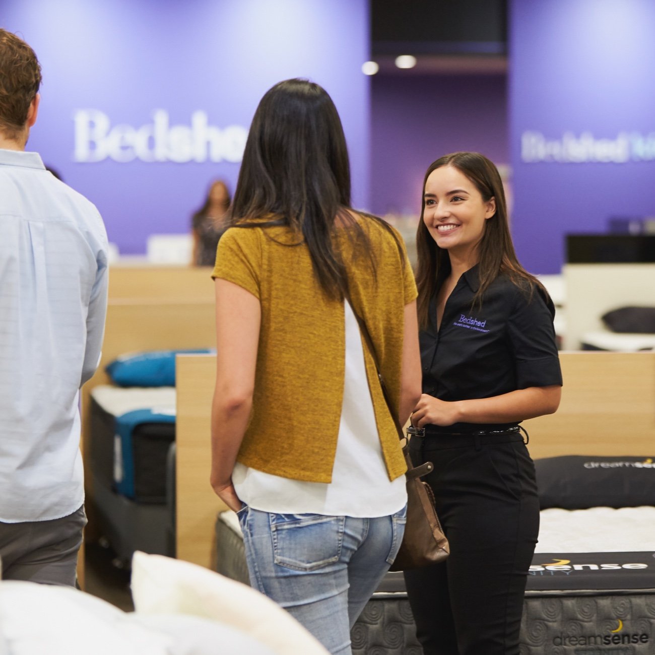 smiling bedshed employee helping customers