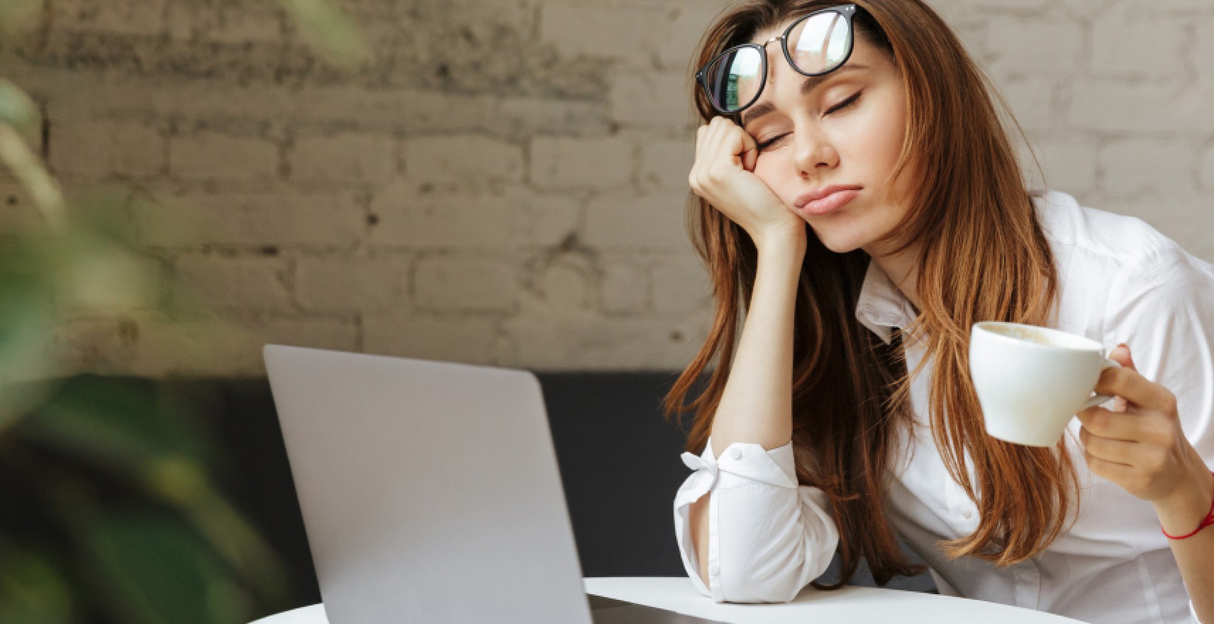 woman nodding off at lap top