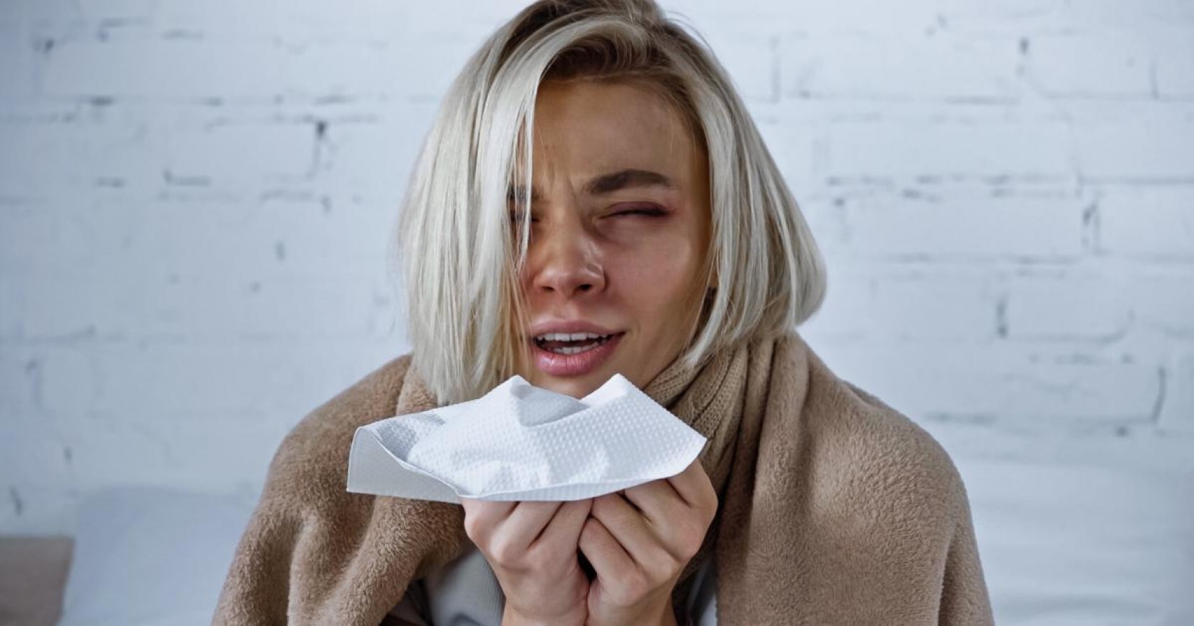 A person sneezing due to hay fever