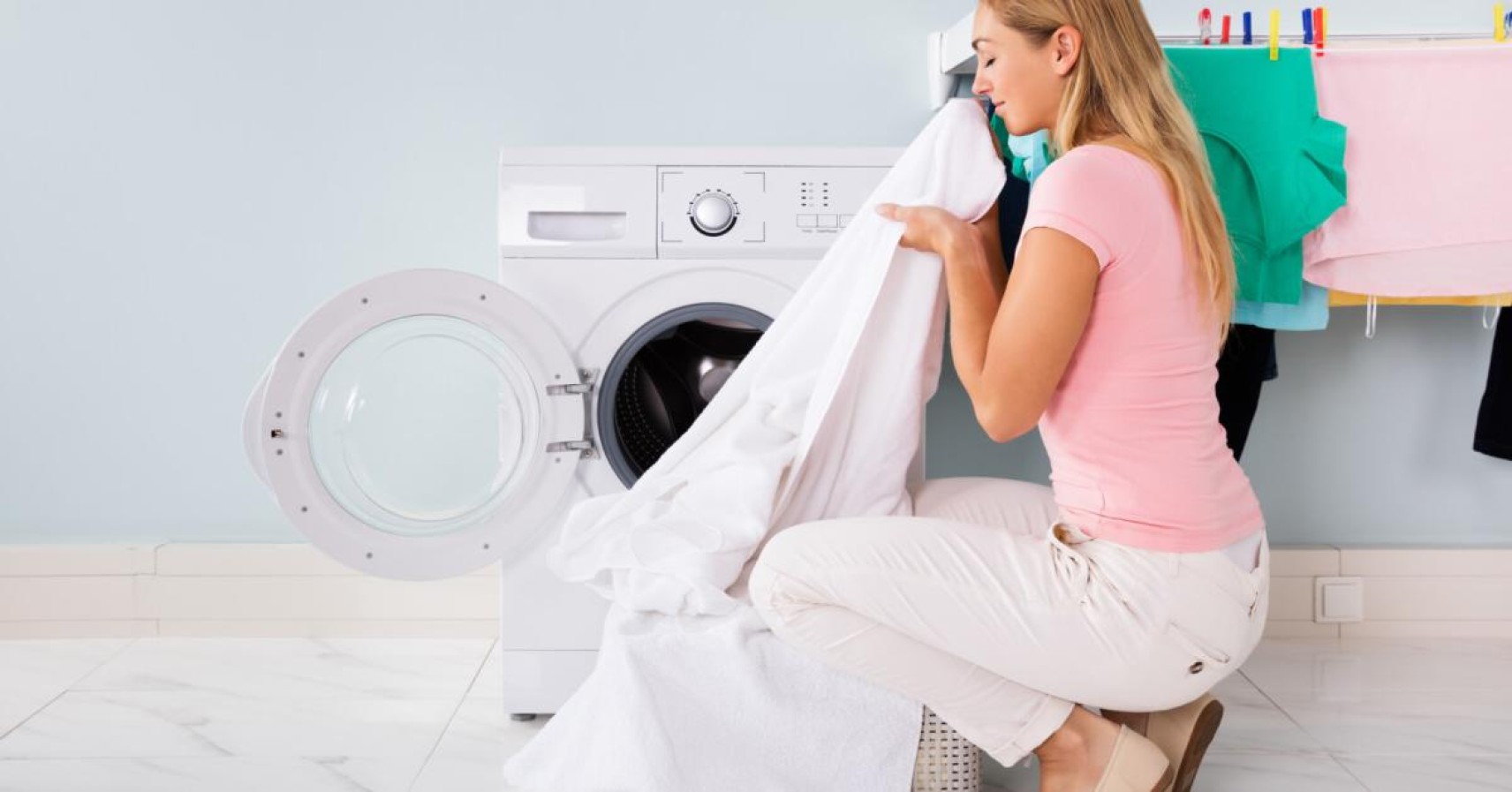 woman smelling freshly washed sheets