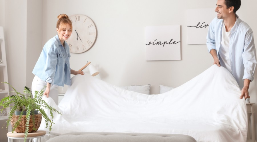 Couple making the bed together