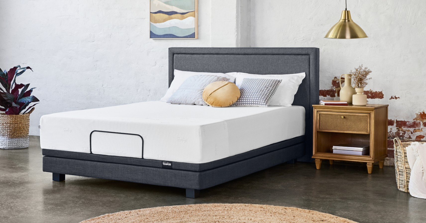 Tempur mattress on a grey upholstered bed frame